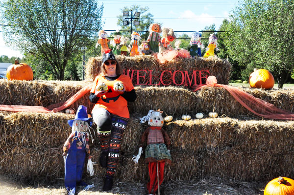 Karen Duquette and the scarecrows at the hay bales and pumkins